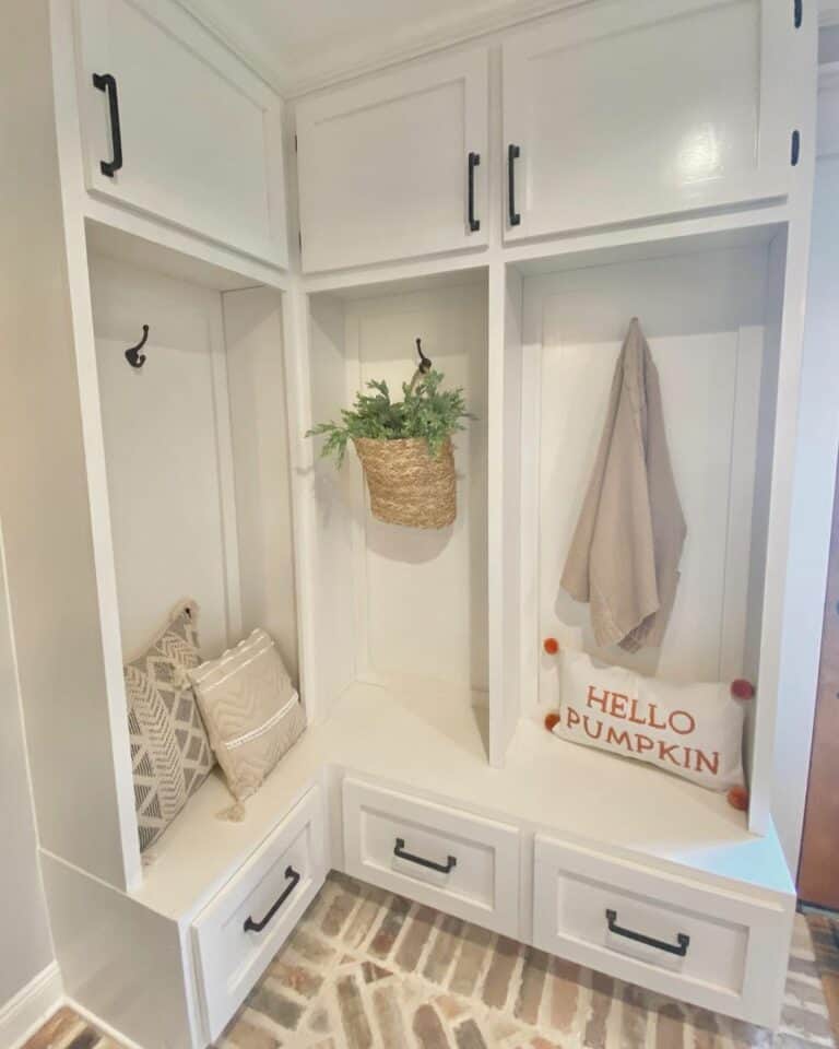 33. Welcome Warmth with a Functional Rustic Mudroom Corner